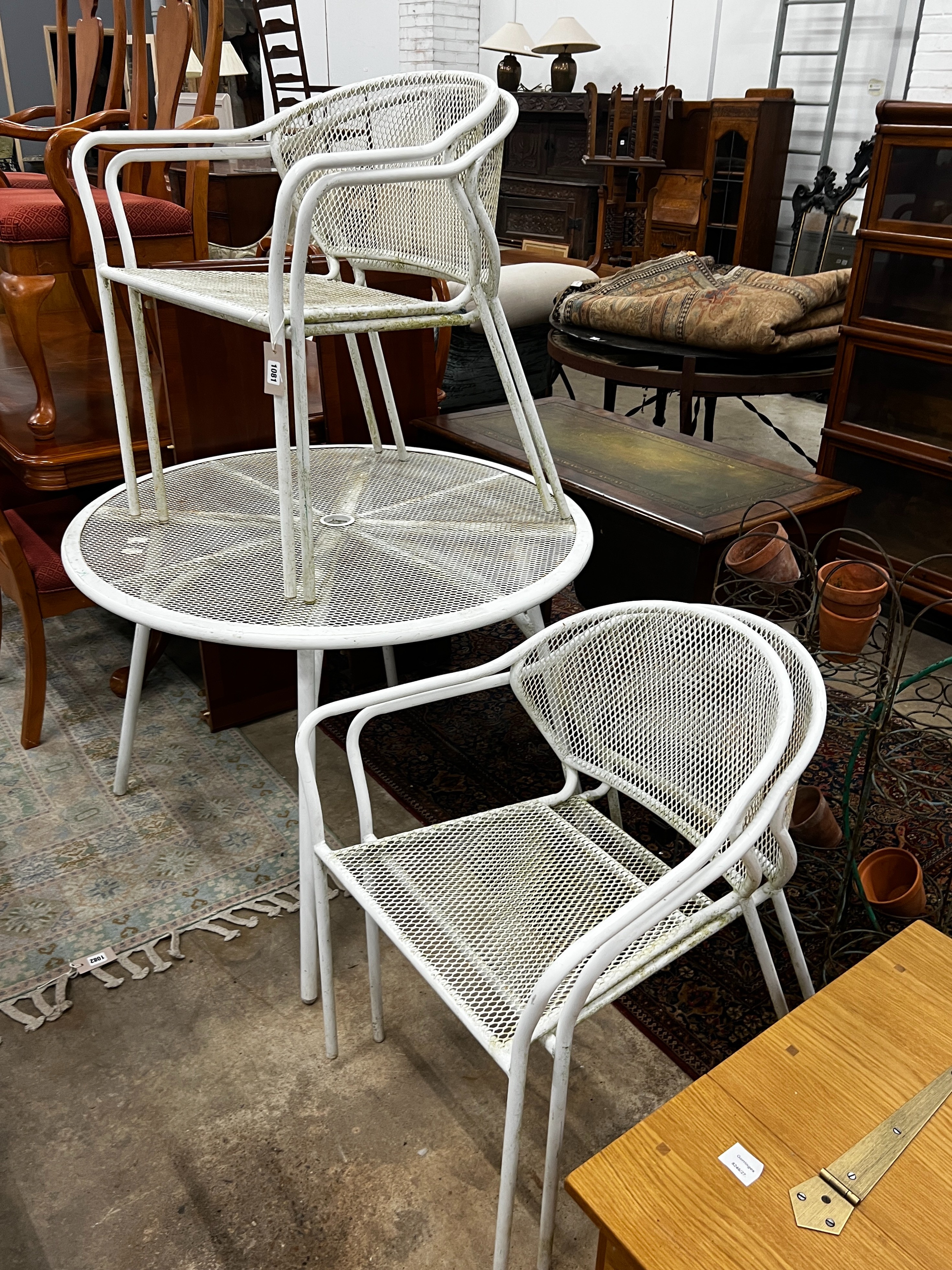 A circular painted aluminium garden table, diameter 100cm, height 72cm together with four matching stacking chairs